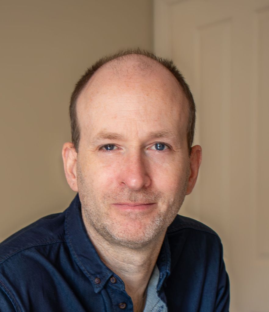 Author smiles to camera